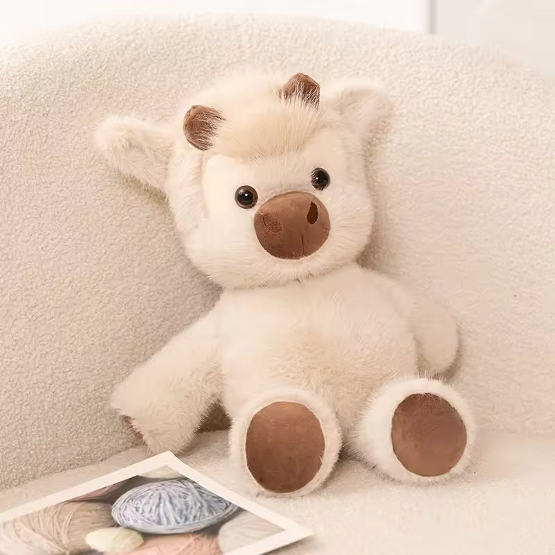 Plush lion toy on a soft surface with yarn and knitting needles.