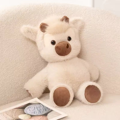 Plush lion toy on a soft surface with yarn and knitting needles.